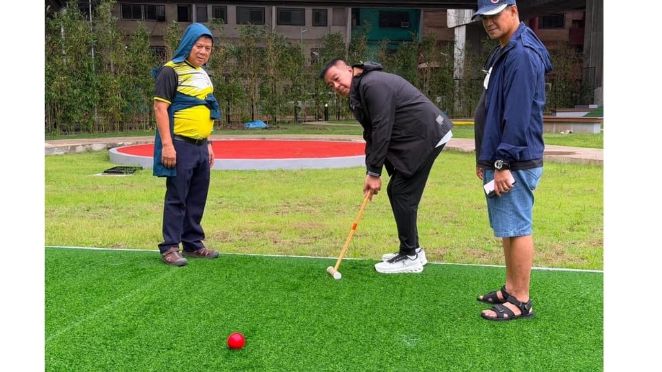 Seniors playing croquet